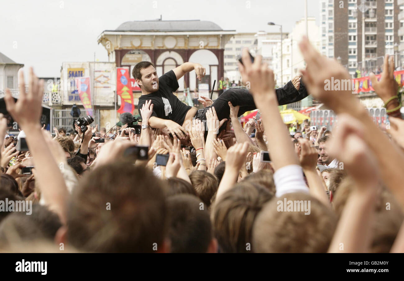 Mike Skinner of The Streets crowd surfs during his performance at the Vodafone TBA concert on Brighton Beach, Brighton. Stock Photo
