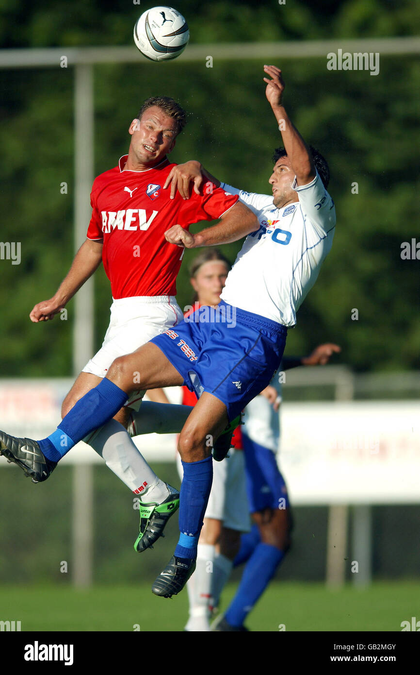 Soccer - Friendly - FC Utrecht v RC Genk. FC Utrecht's Hans van de Haar (L) and RC Genk's Akram Roumani (R) battle for the ball in the air Stock Photo