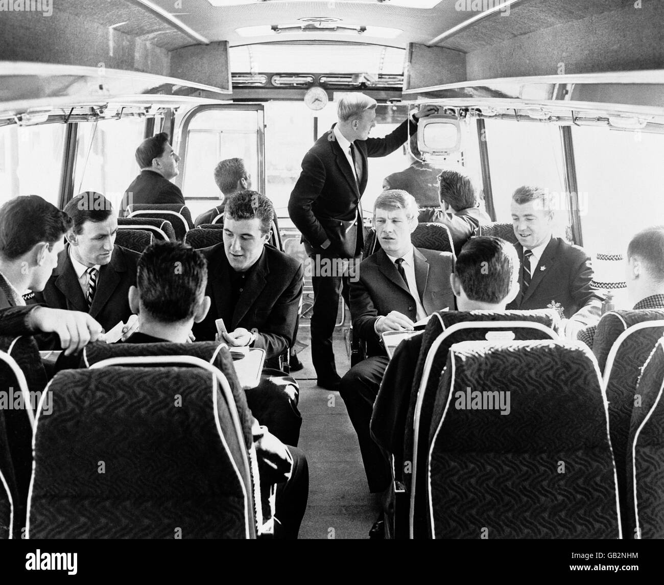 Wolverhampton Wanderers' Chris Crowe (c) turns on the television during the coach journey from Wolverhampton to Leicester as his teammates continue their card schools. Playing cards are (l-r, facing camera) Jimmy Murray, Fred Davies, Alan Hinton, George Showell Stock Photo