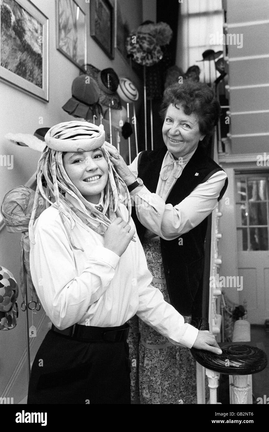 Simone Mirman with model Virginie at her shop. Virginie wears a predominantly shocking pink mid-1960's creation from the Mirman Collection, auctioned at Christie's on 13th September 1982. Threr was over 500 hats dating back to the late 1950's. Stock Photo