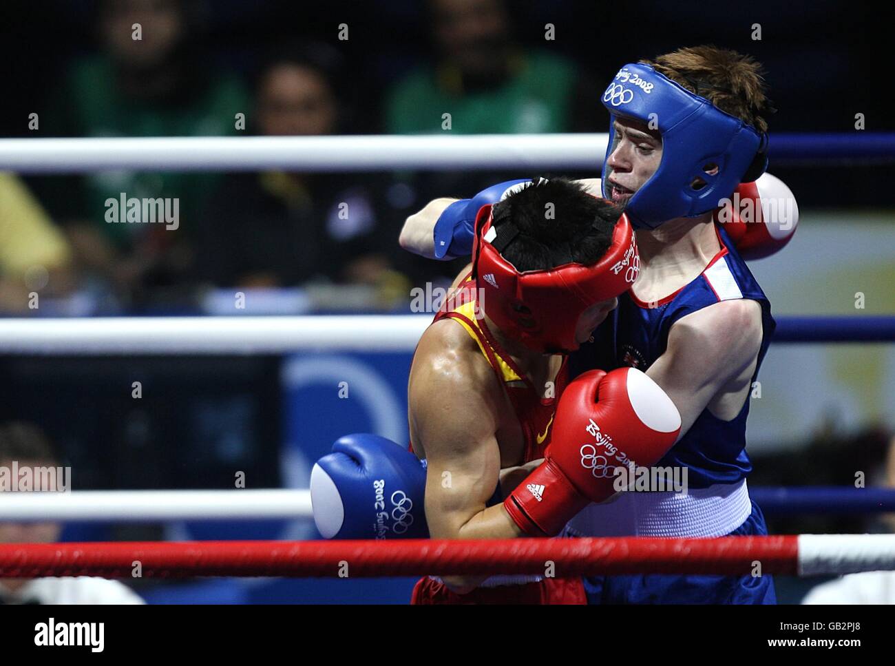 China's Yu Gu (red) and Great Britain's Joe Murray (blue) trade punches ...