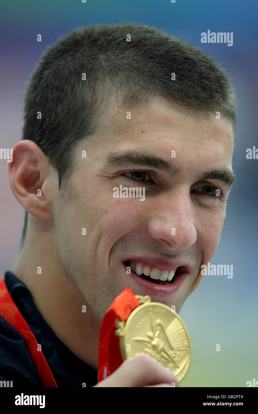 United States' Michael Phelps with the gold medal he won in the men's 200m Individual Medley final at the National Aquatic Center during the 2008 Beijing Olympic Games in China. Stock Photo