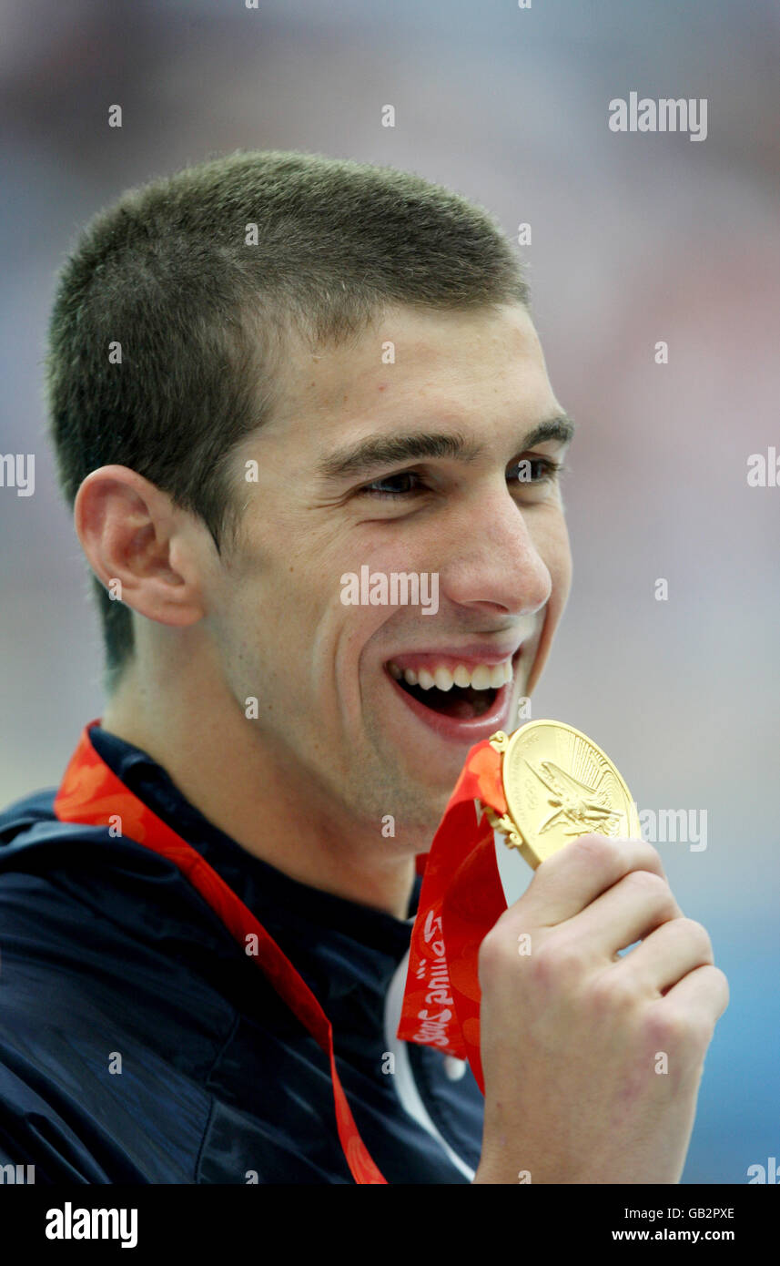 Olympics - Beijing Olympic Games 2008 - Day Seven. United States Michael Phelps celebrates with his gold medal from the men's 200m Individual Medley. Stock Photo