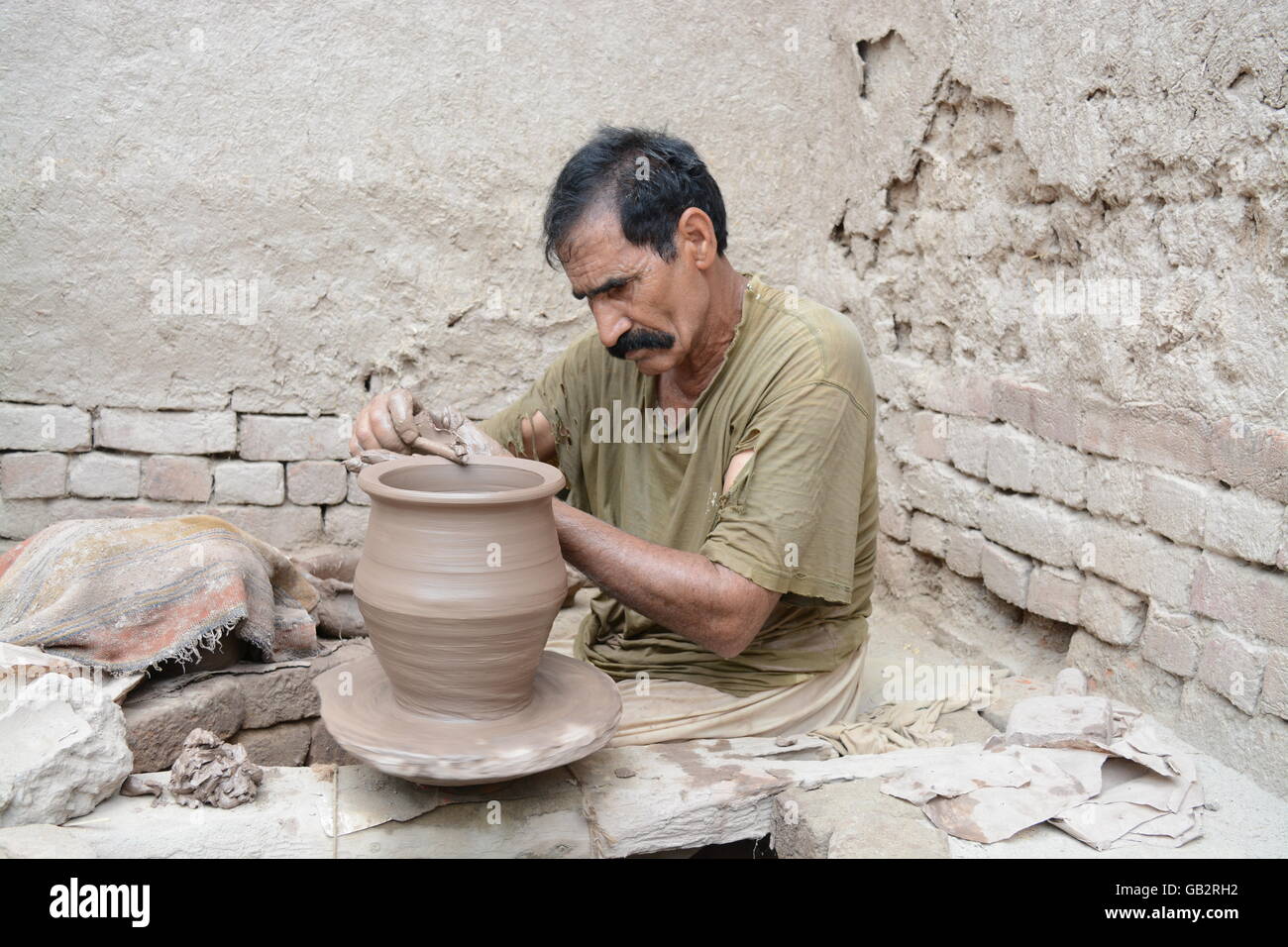 Potter at work at his pottery wheel 