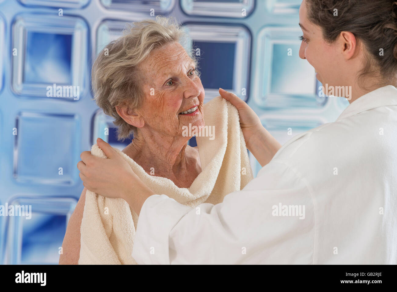Care giver or nurse assisting elderly woman for shower Stock Photo