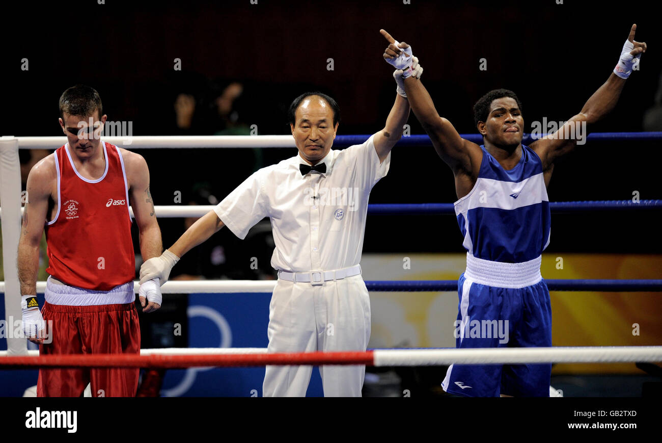 Dominican Republic's Felix Diaz celebrates after beating Ireland's Johnny Joyce (red) during their second round light welterweight bout at the Beijing Workers Gymnasium in Beijing, China. Stock Photo