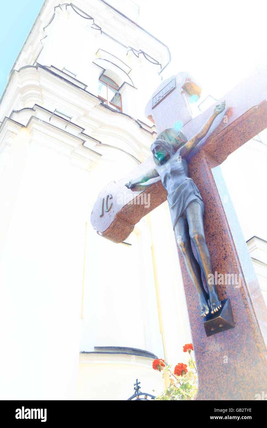 Jesus on wooden cross in a background of church with glimpse sunshine Stock Photo