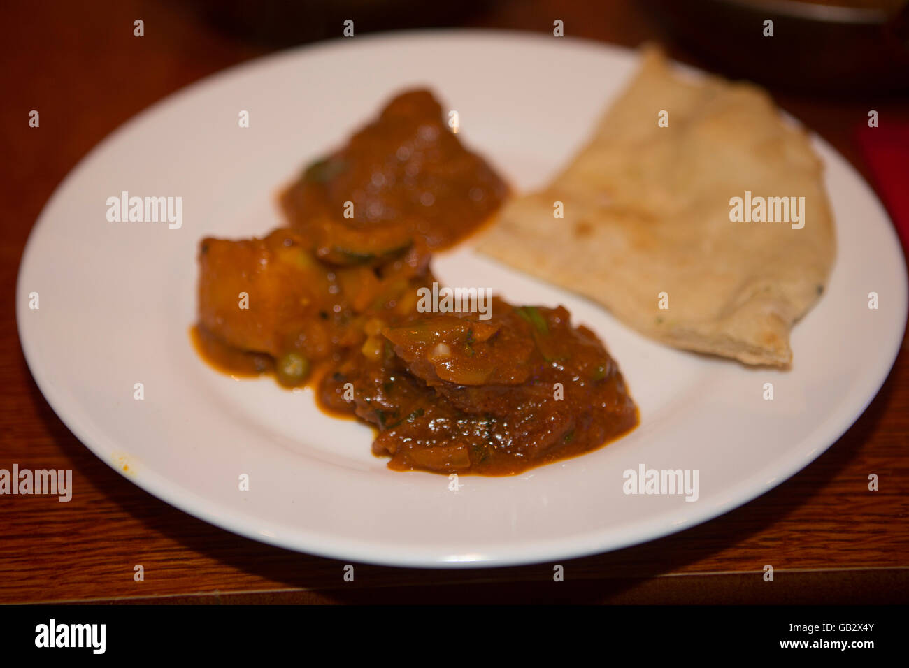 Curry served in Brick Lane, London, England. Many of the curry restaurants are operated by Bangladeshi families. Stock Photo