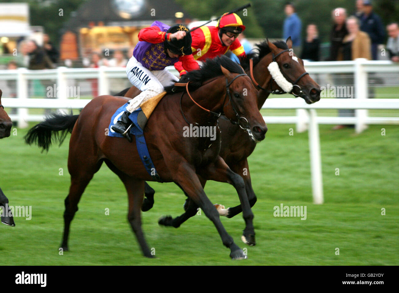 Kingdom of Fife (l) ridden by jockey Ryan Moore ahead of Albarouche ridden by Philip Robinson during the Lamb Building Civil And Public Teams Handicap Stock Photo