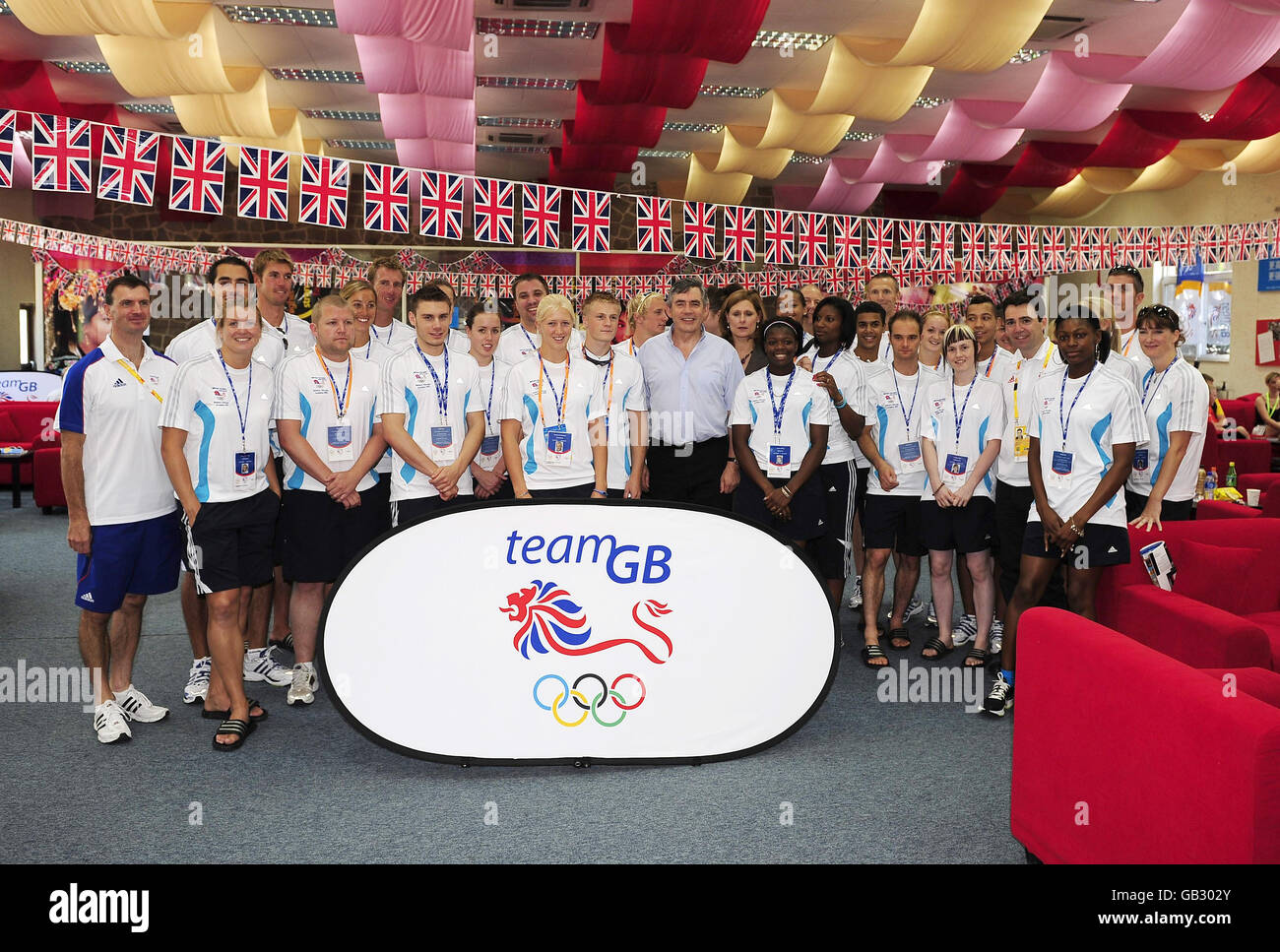 RETRANSMISSION with improved quality. Prime Minister Gordon Brown stands with members of Team GB during a visit to their Athletics Lodge in Beijing where he is attending the final days of the 2008 Olympic Games in China. Stock Photo