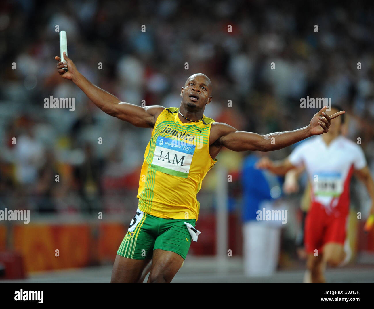 Jamaica's Asafa Powell celebrates after Jamaica win the 4x100m relay in a new world record time at the National Stadium in Beijing during the 2008 Beijing Olympic Games in China. Stock Photo