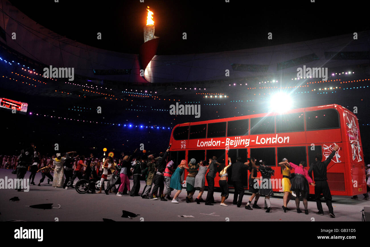 A double decker bus arrives during the Closing Ceremony at the National Stadium during the 2008 Beijing Olympic Games, China. Stock Photo