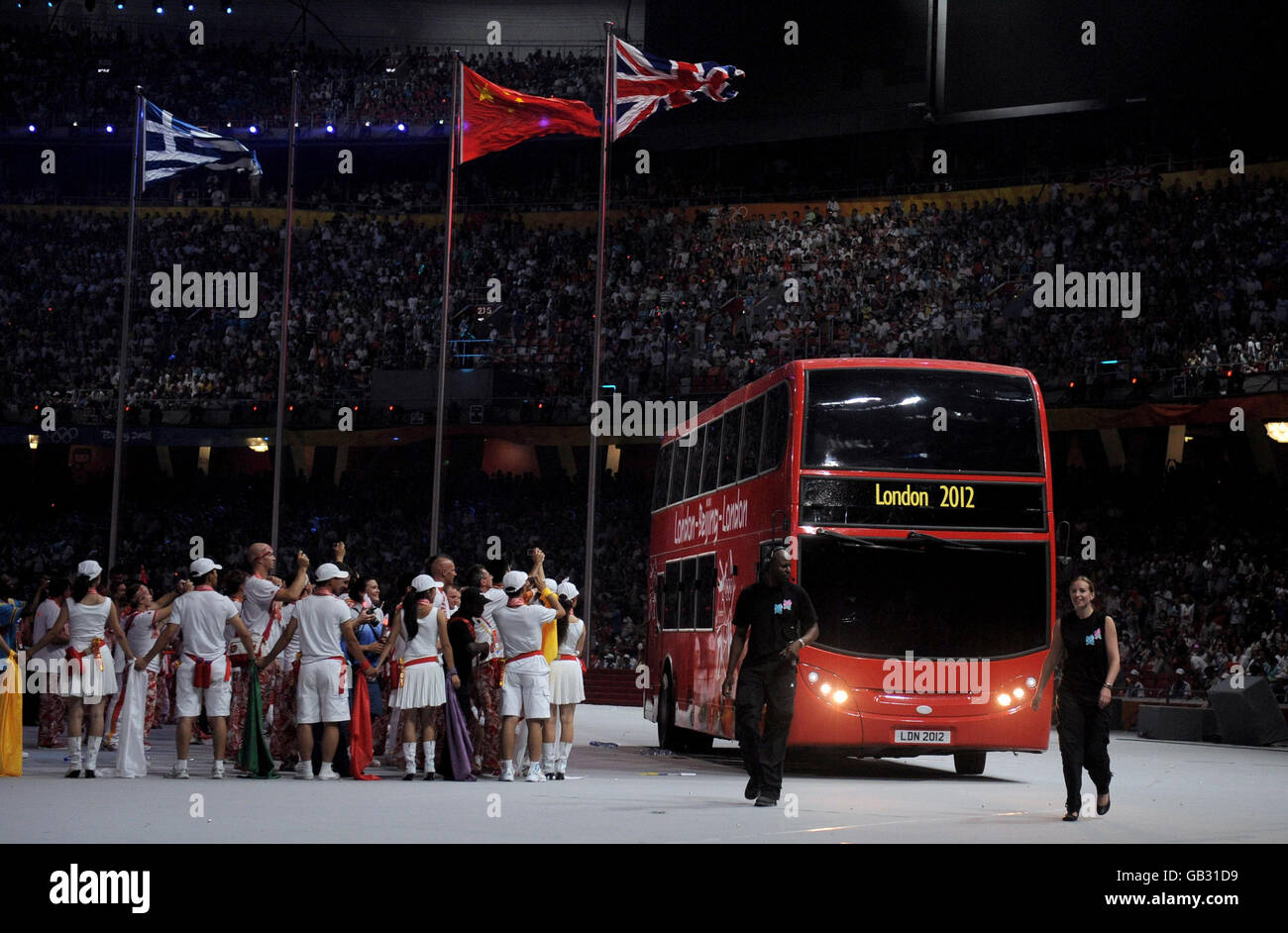 A double decker bus arrives during the Closing Ceremony at the National Stadium during the 2008 Beijing Olympic Games, China. Stock Photo