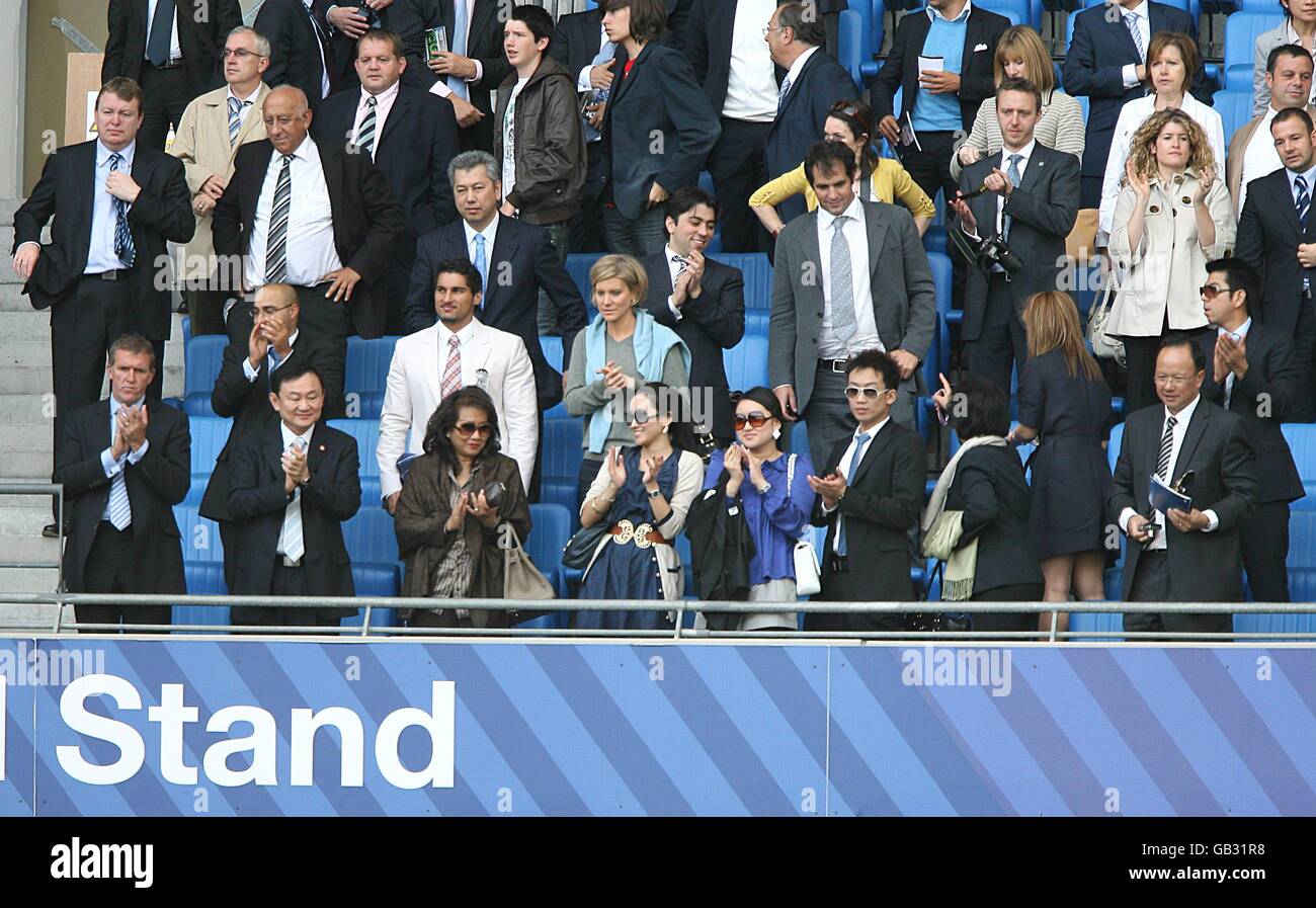 Manchester City's owner Thaksin Shinawatra (2nd left front row) and his family celebrate in the stands after the final whistle. Carlos Tevez's agent Kai Joorbchain stands behind them (4th left 3rd row back clapping) Stock Photo