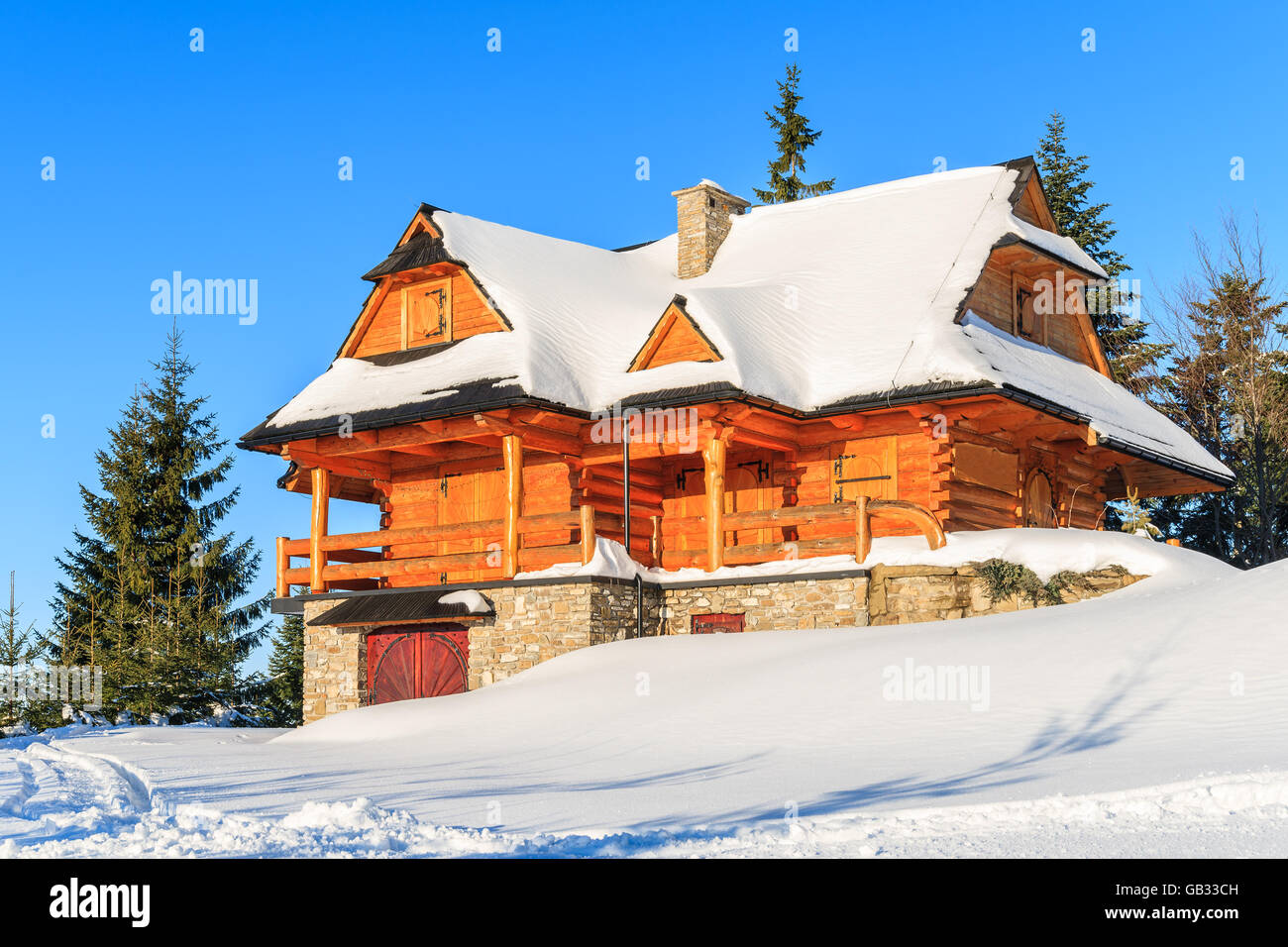 Mountain house covered with fresh snow in Gorce Mountains in winter season, Poland Stock Photo