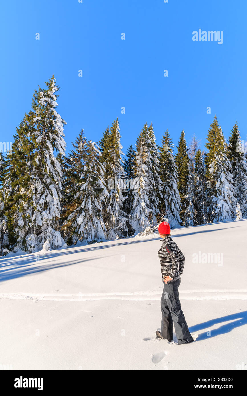 Young woman tourist on winter trail in Gorce Mountains, Poland Stock Photo