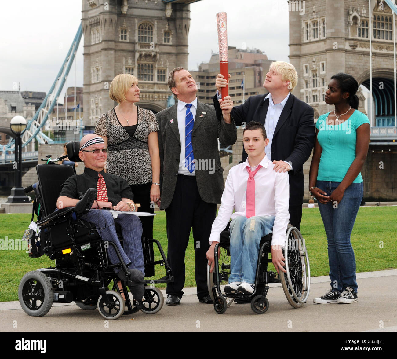(left to right) GLA disabled rights adviser, David Morris, volunteer Michelle Martin, Chairman of the British Paralympics Association, Mike Brace, Daniel Lucker, who competed in the London Mini Wheelchair Marathon, Mayor of London Boris Johnson, holding a Beijing 2008 Olympics torch and Dominique Alexander-Ellis, a judo competitor, at Tower Bridge, central London, today. Stock Photo