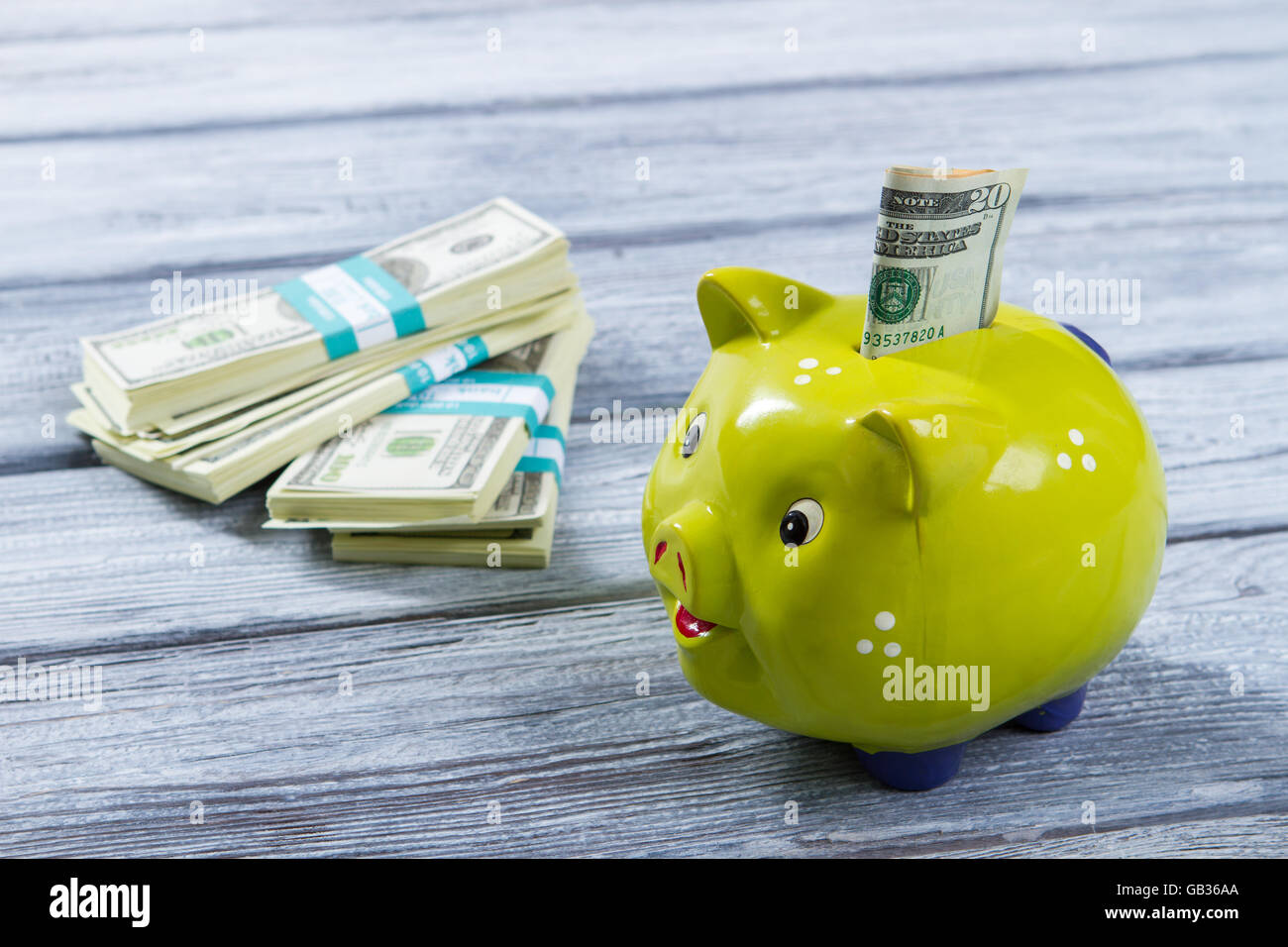 Folded dollars in piggy bank. Money box of lime color. Earn money for