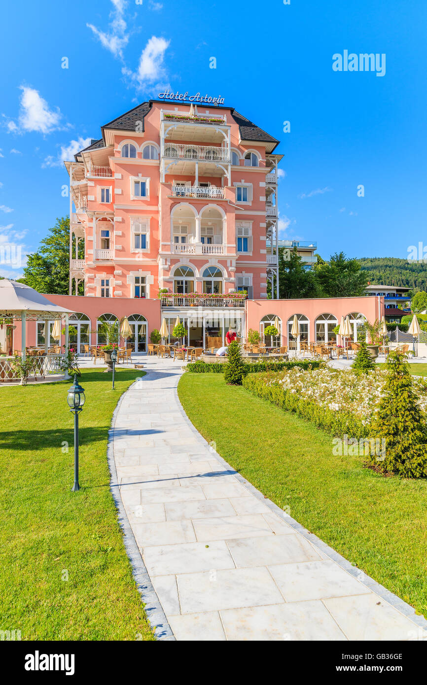 WORTHERSEE LAKE, AUSTRIA - JUN 20, 2015: luxury hotel Astoria and its gardens on shore of beautiful alpine lake Worthersee in su Stock Photo