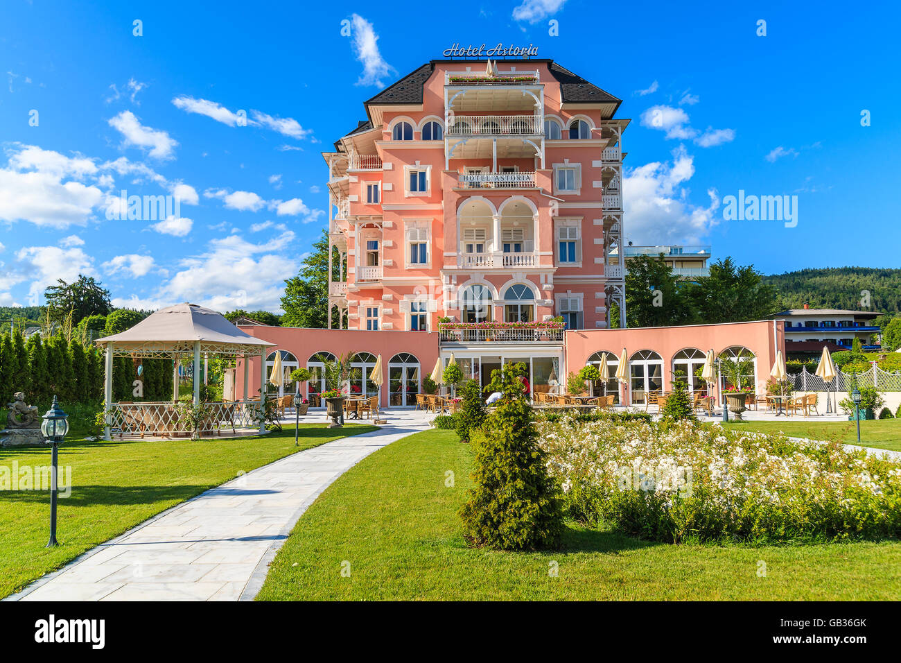 WORTHERSEE LAKE, AUSTRIA - JUN 20, 2015: luxury hotel Astoria and its gardens on shore of beautiful alpine lake Worthersee in su Stock Photo