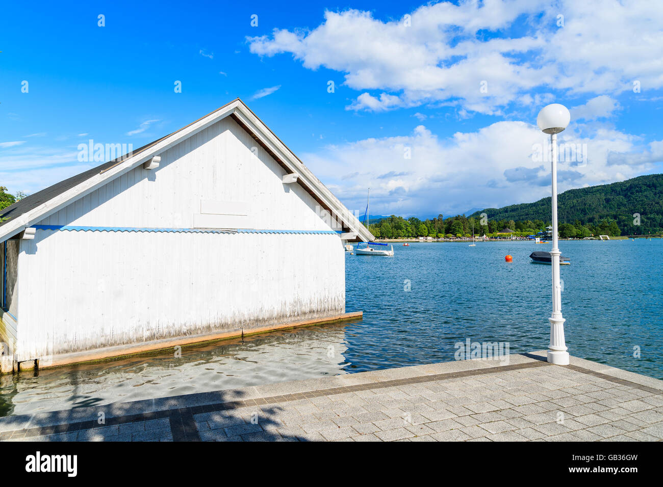 White wooden boat house on shore of Worthersee lakeduring summer time, Austria Stock Photo