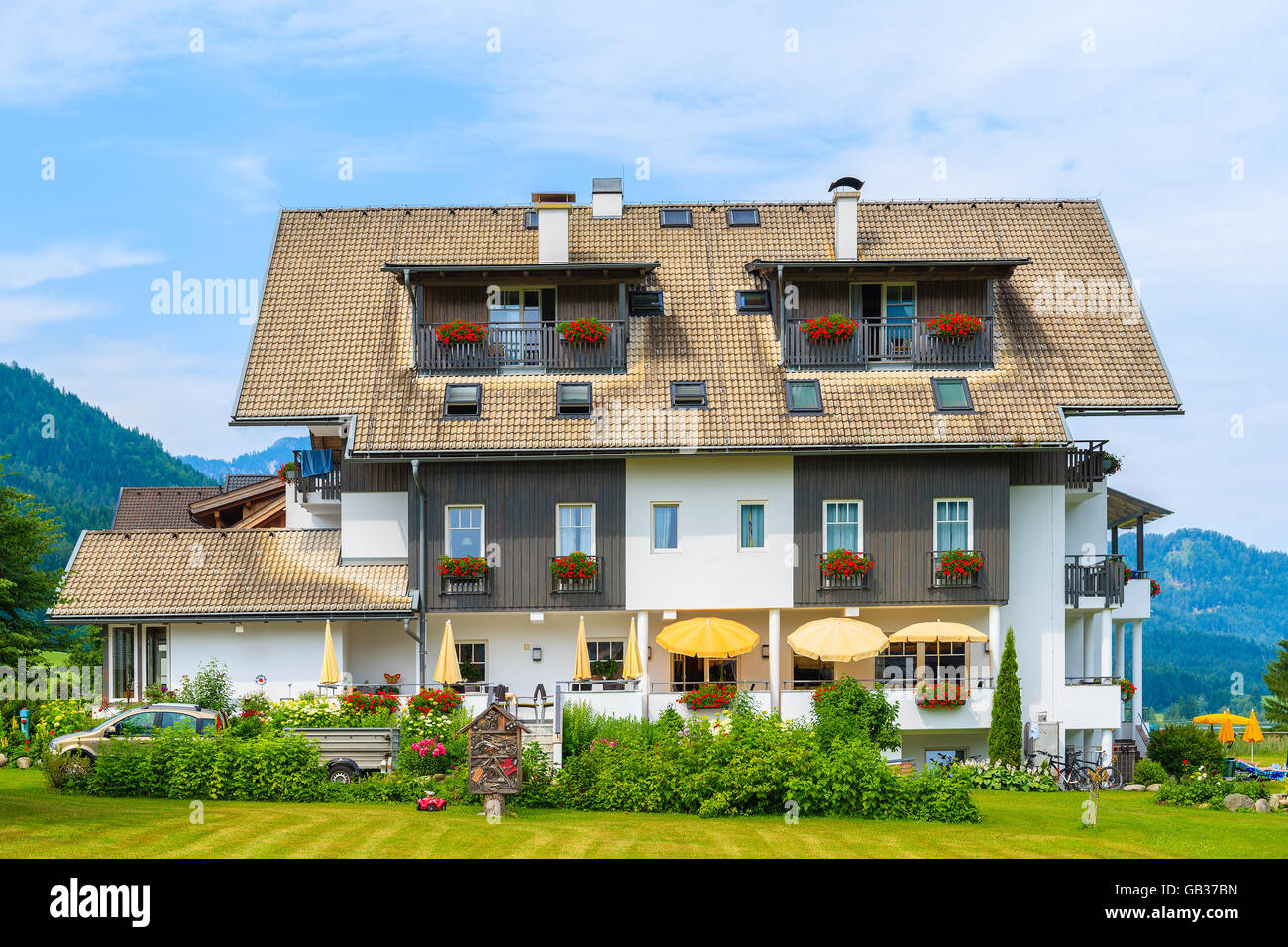 Traditional alpine house in a village on shore of Weissensee lake in summer time, Austria Stock Photo