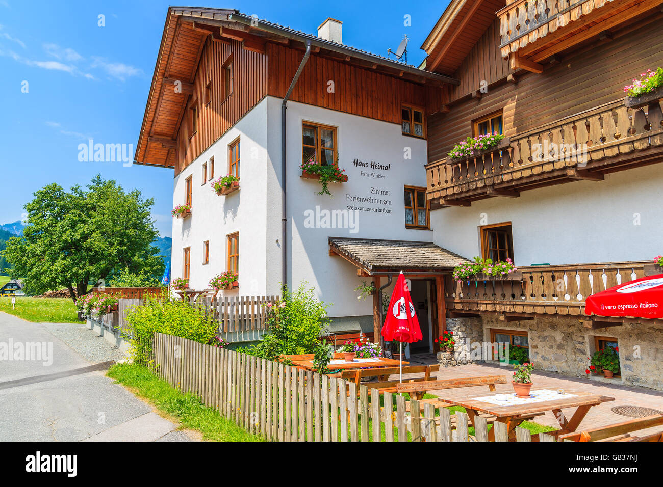 WEISSENSEE LAKE, AUSTRIA - JUL 6, 2015: beautiful guest house in small alpine village on shore of Weissensee lake in summer time Stock Photo