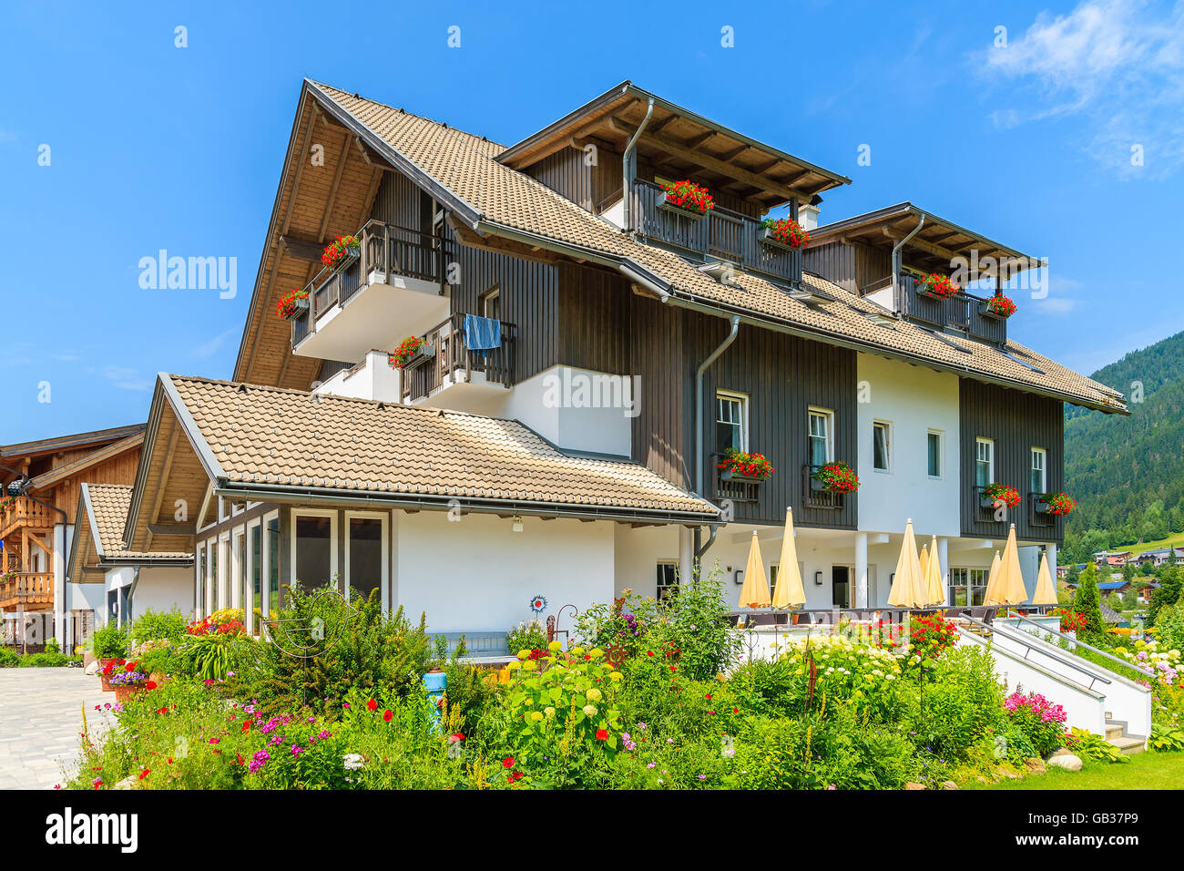 Traditional alpine house in a village on shore of Weissensee lake in summer time, Austria Stock Photo