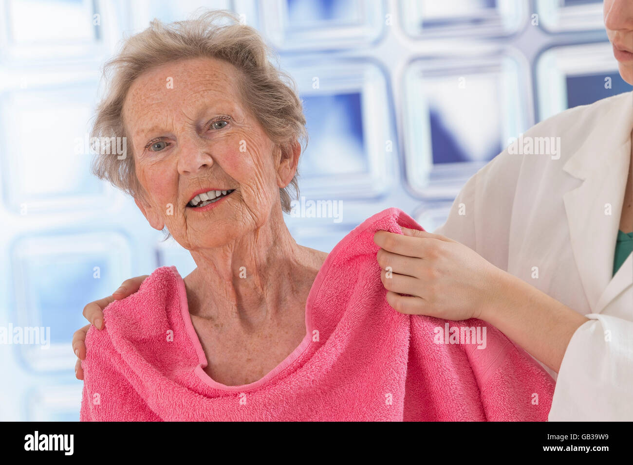 Care giver or nurse assisting elderly woman for shower Stock Photo