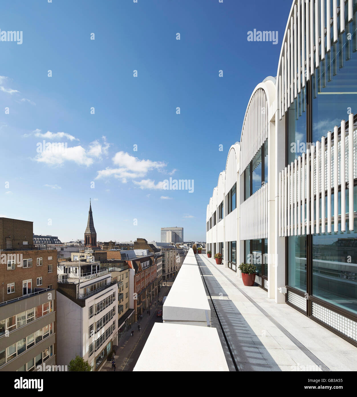 View along top floor terrace with cityscape. Fitzroy Place, London, United Kingdom. Architect: Lifschutz Davidson Sandilands, 2015. Stock Photo