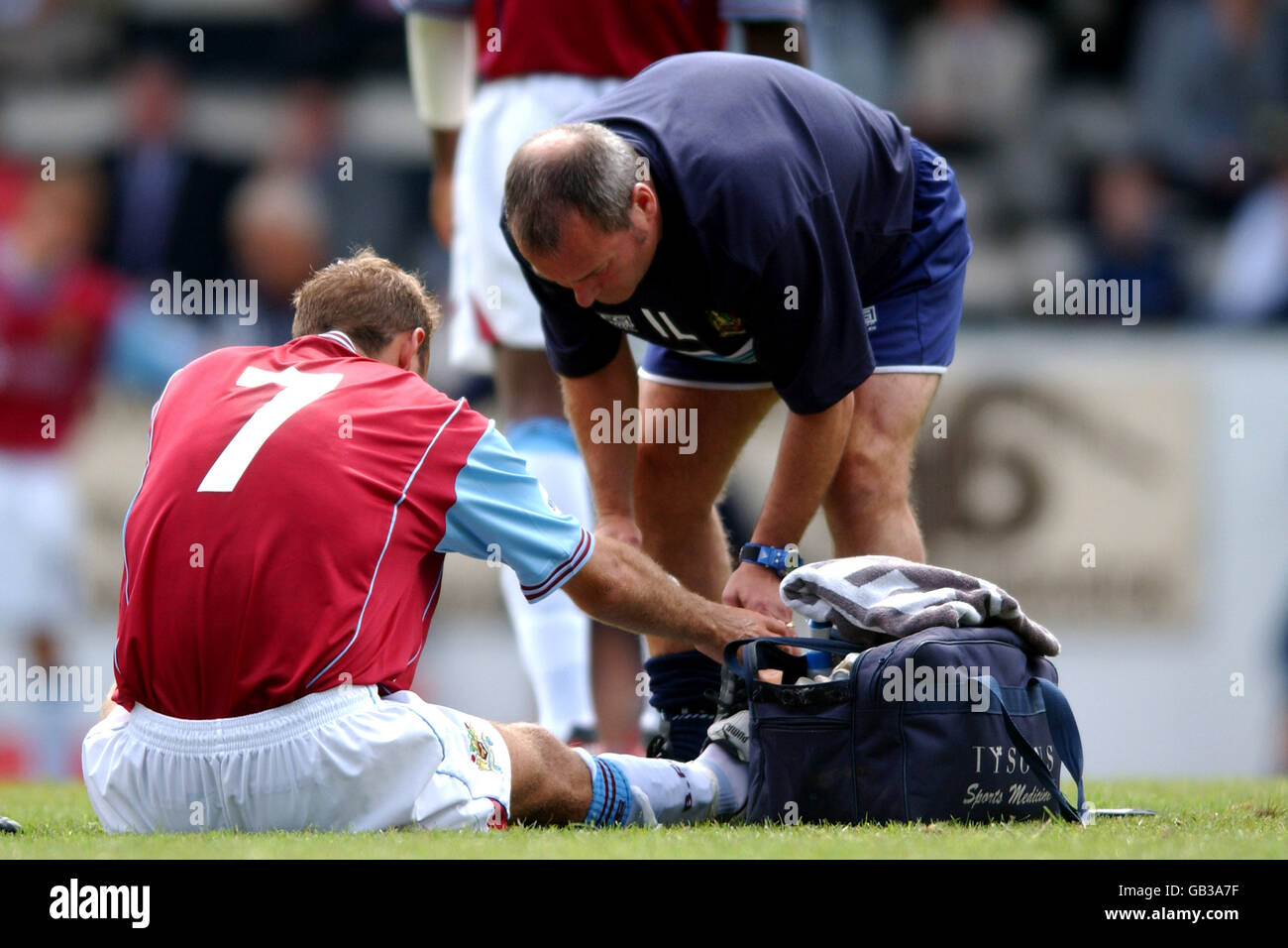 Burnley physio Ian Liversedge treats the injured Glen Little Stock Photo