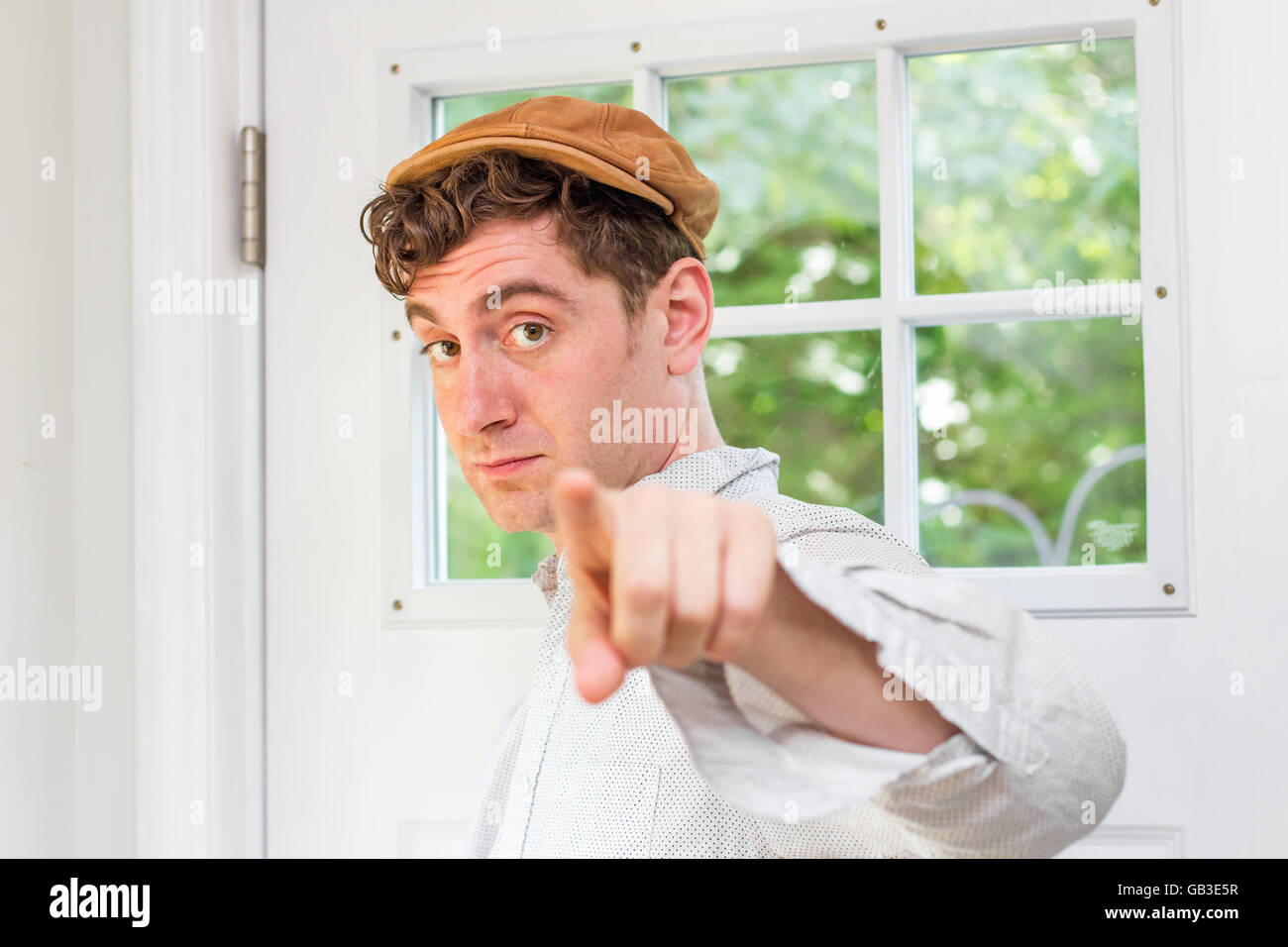 Young Handsome Curly Haired Man Wearing Newsboy Hat Points Finger Stock Photo Alamy Young Handsome Curly Haired Man Wearing Newsboy Hat Points Finger Stock Photo Alamy