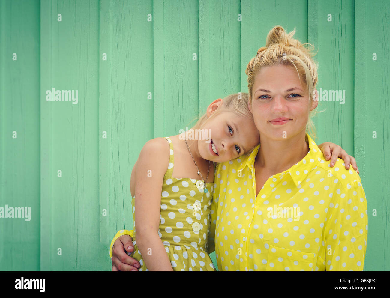 Two blondes Mom and daughter smiling. Space for text Stock Photo