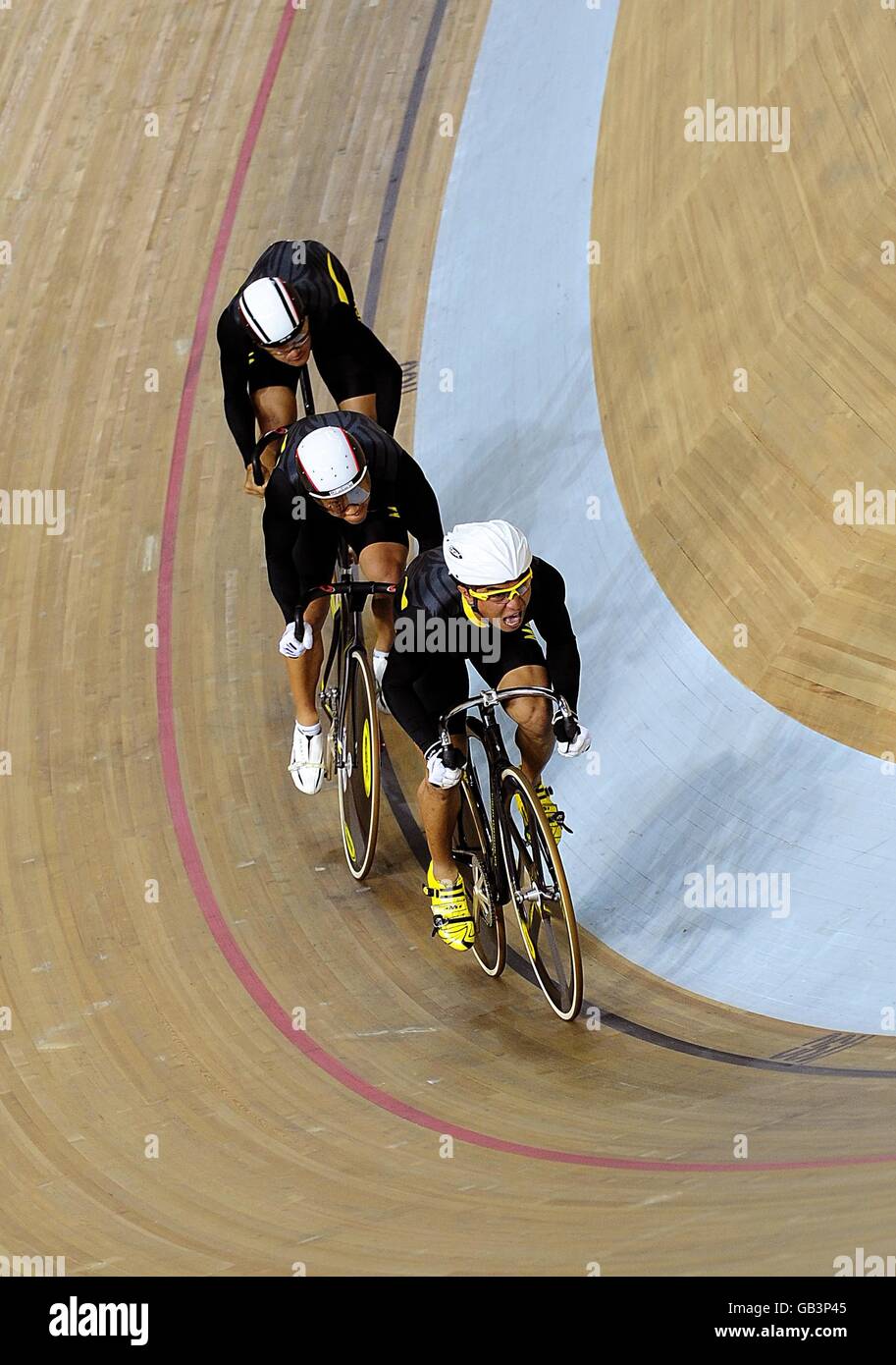 The Malaysian team in action during the qualifying round of the Track Cycling Men's Team Sprint event at the Losham Velodrome in Beijing, China, during the 2008 Beijing Olympic Games. Stock Photo