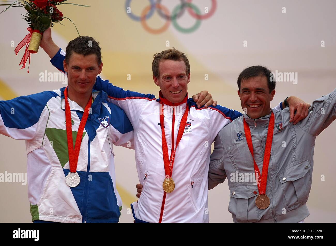(left to right) Slovenia's Vasilij Zbogar with his silver medal, Great Britain's Paul Goodison with gold and Italy's Diego Romero with bronze during the medal ceremony of the Laser men's class Stock Photo