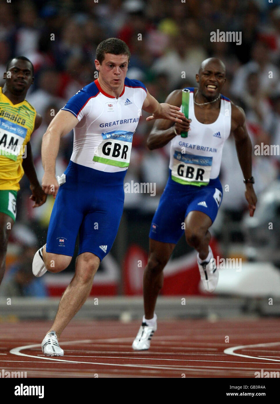 Great Britain's Craig Pickering (left) steps just outside of the permitted area to receive the handover of the baton from team mate Marlon Devonish (right) leading to Great Britain's disqualification from the men's 4x100 relayl at the National Stadium in Beijing during the 2008 Beijing Olympic Games in China. Stock Photo