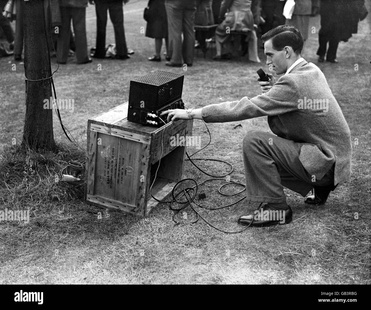A radio outside-broadcaster prepares his equipment. Stock Photo
