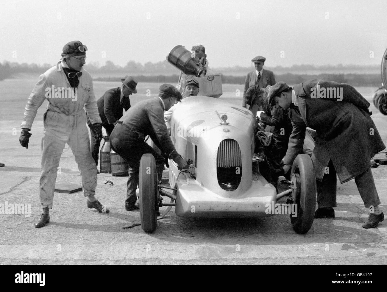 The Alfa Romeo of George Eyston and his co-driver RC Stewart is attended to by mechanics before a record attempt. Stock Photo