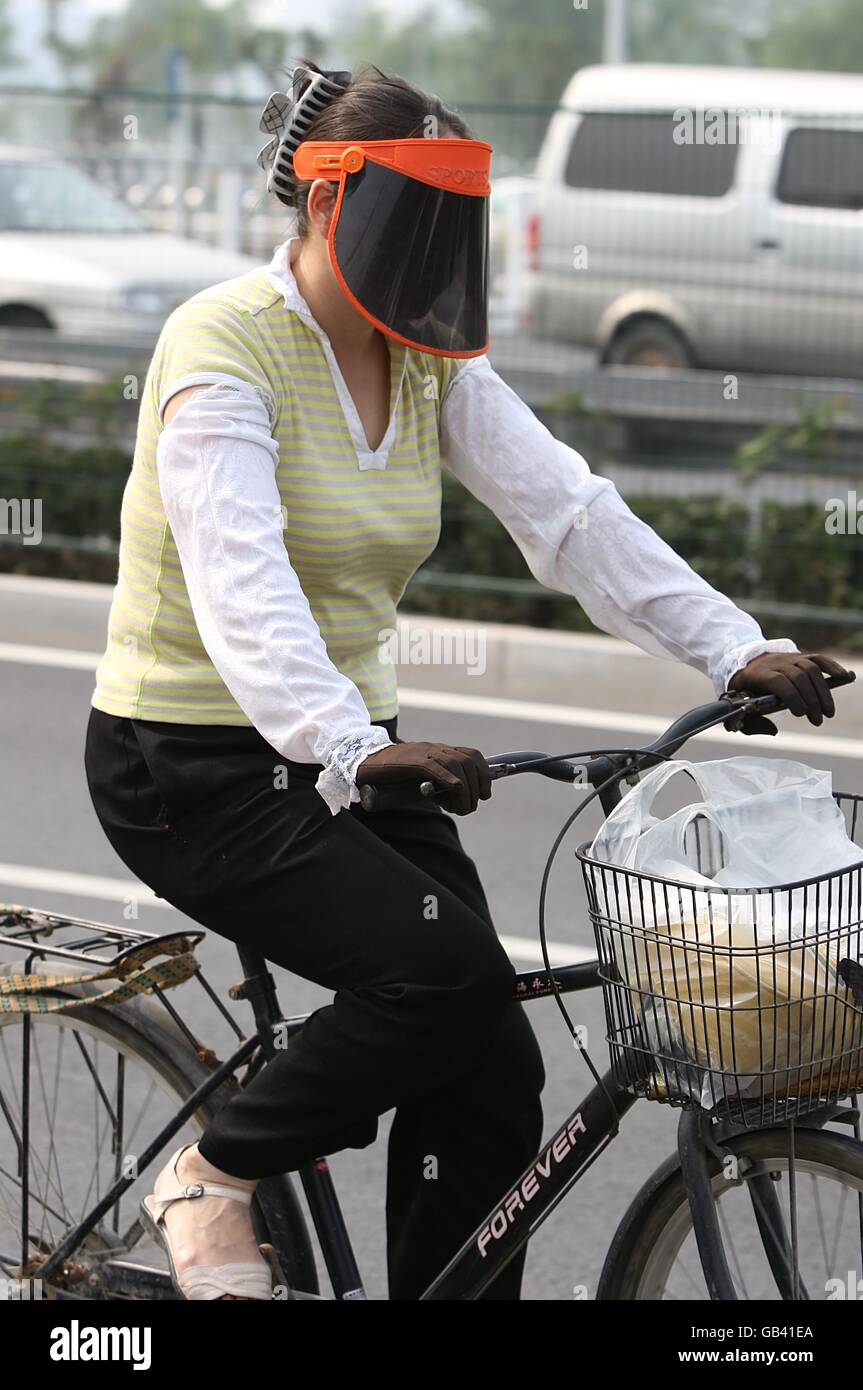 Olympics - Beijing Olympic Games 2008. A local woman takes precautions against the pollution prior to the 2008 Olympic Games in Beijing, China. Stock Photo