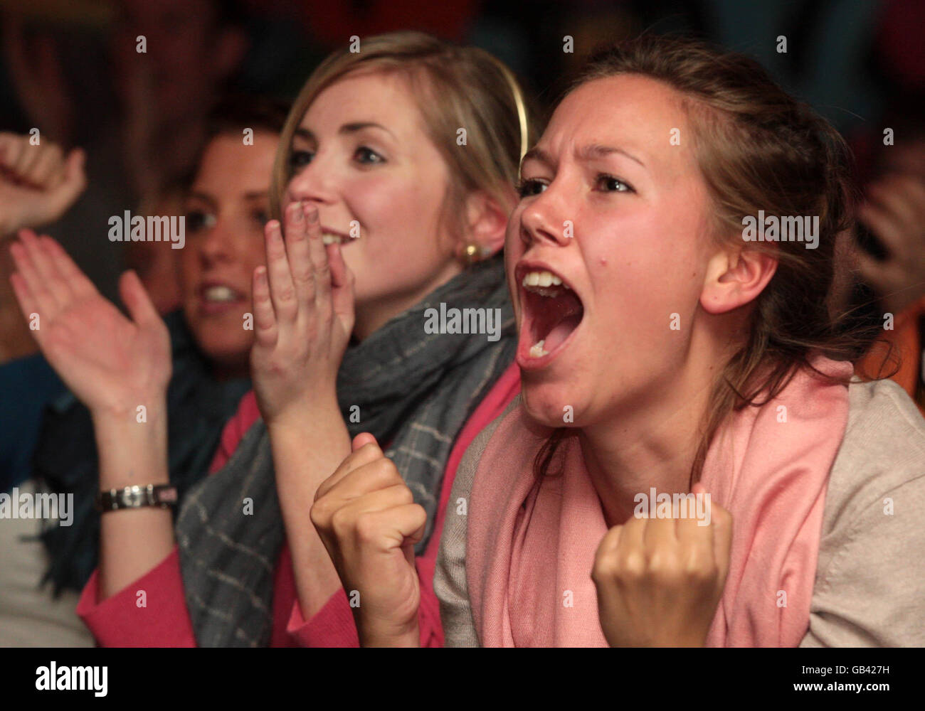 Fans watch the US Open Final between Great Britain's Andy Murray and Switzerland's Rodger Federer on a screen at the sports centre in Dunblane. Stock Photo
