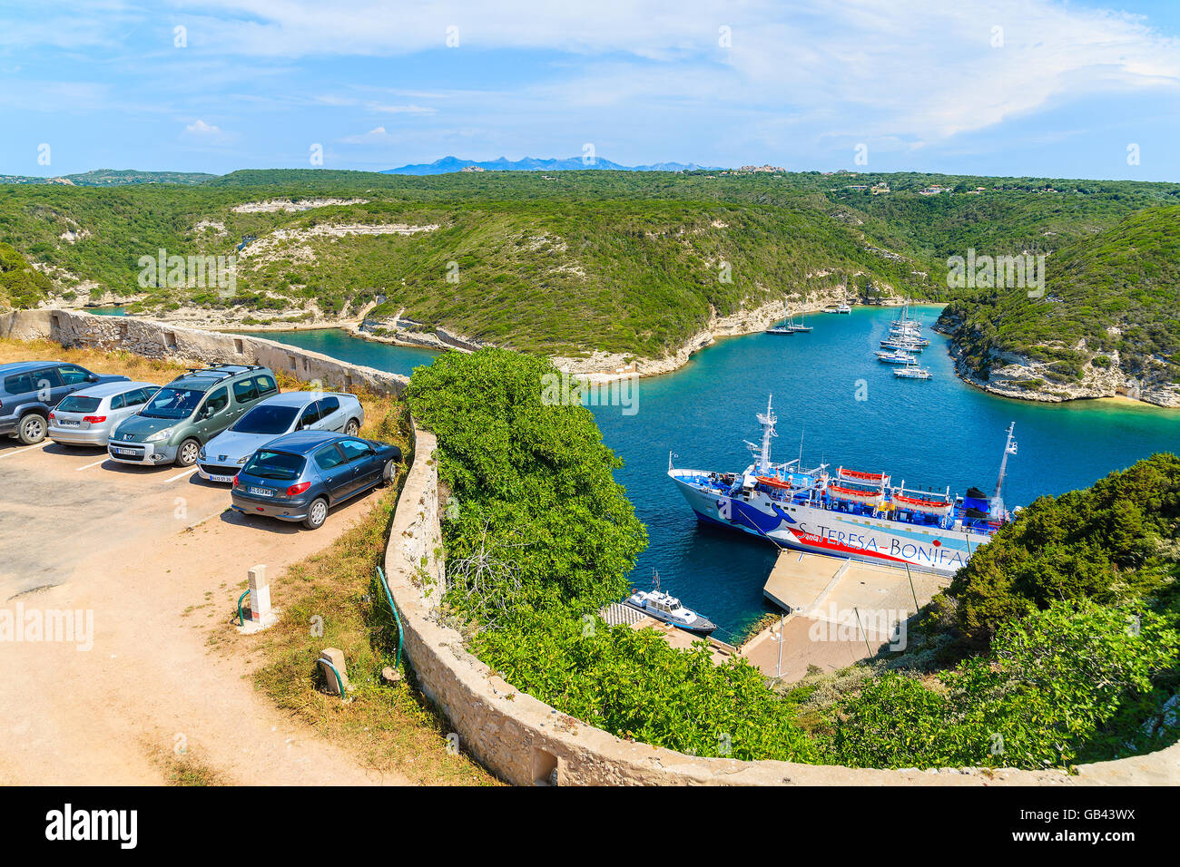 CORSICA ISLAND, FRANCE - JUN 23, 2015: cars parking and ferry boat in Bonifacio port waiting for its daily cruise to Santa Teres Stock Photo