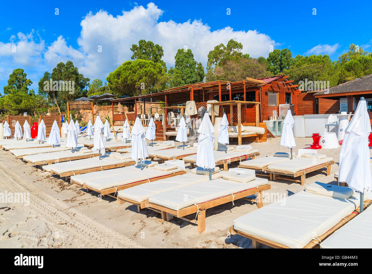 PALOMBAGGIA BEACH, CORSICA ISLAND - JUN 23, 2015: sunbeds in front of a restaurant on sandy Palombaggia beach, Corsica island, F Stock Photo