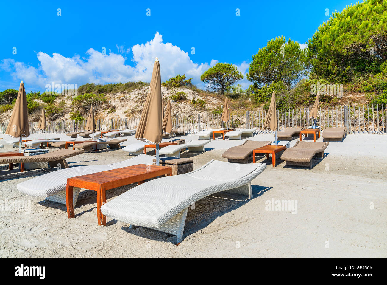 Sunbeds on Palombaggia beach on sunny summer day, Corsica island, France Stock Photo