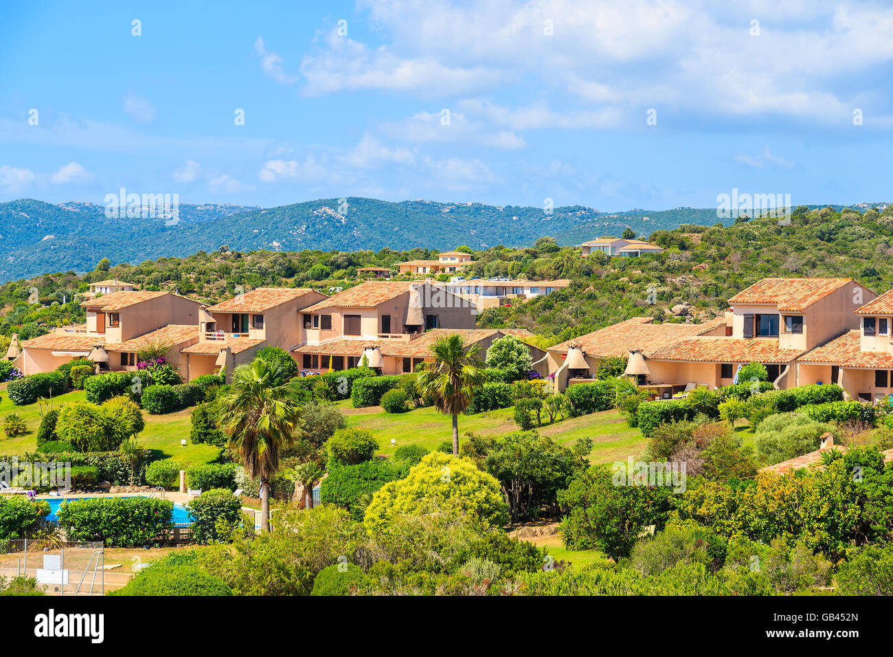 Typical Corsican villa houses on green hill in rural landscape of Corsica island, France Stock Photo