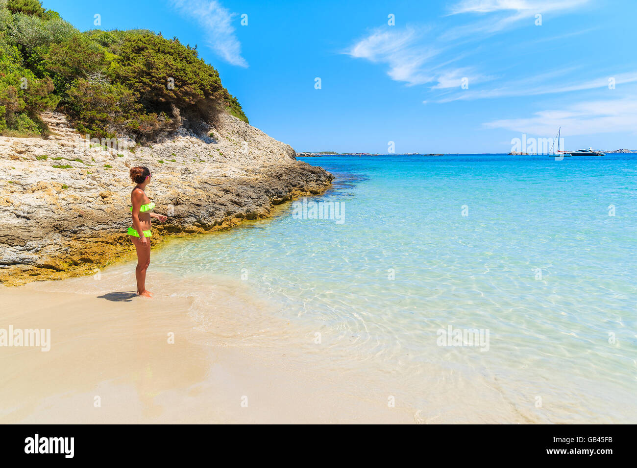 Unidentified attractive young woman in swimsuit standing on beautiful Petit Sperone beach on Corsica island, France Stock Photo