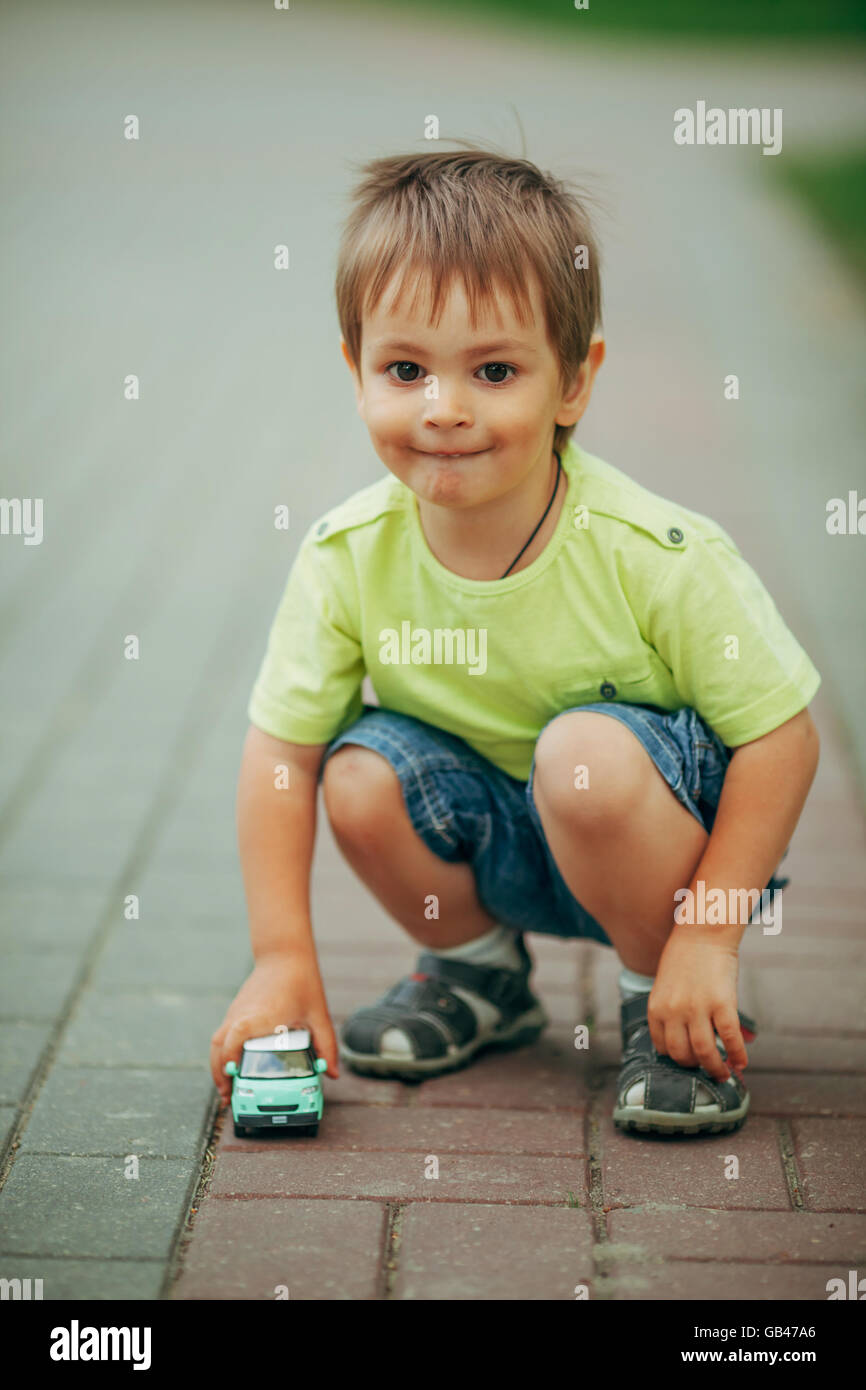 little boy playing with toy car Stock Photo - Alamy