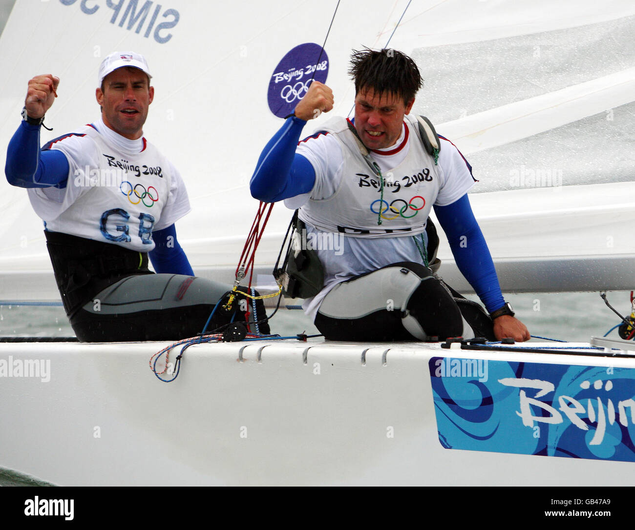 Great Britain's duo of Iain Percy (left) and Andrew Simpson celebrate after winning a Gold Medal in the Star class at the 2008 Beijing Olympic Games' Sailing Centre in Qingdao, China. Stock Photo