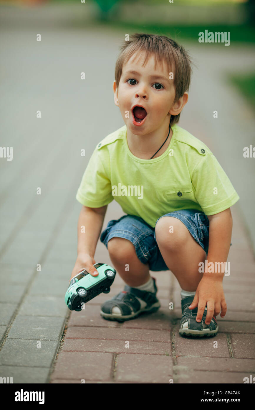 little boy playing with toy car Stock Photo - Alamy