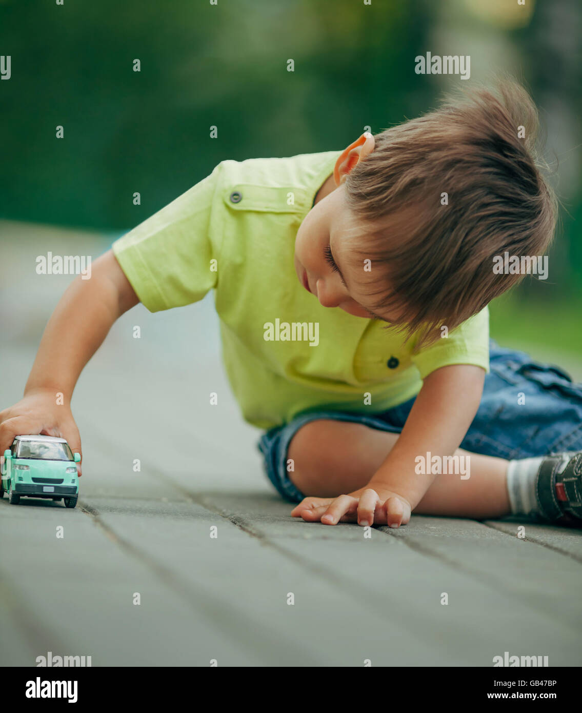 little boy playing with toy car Stock Photo - Alamy