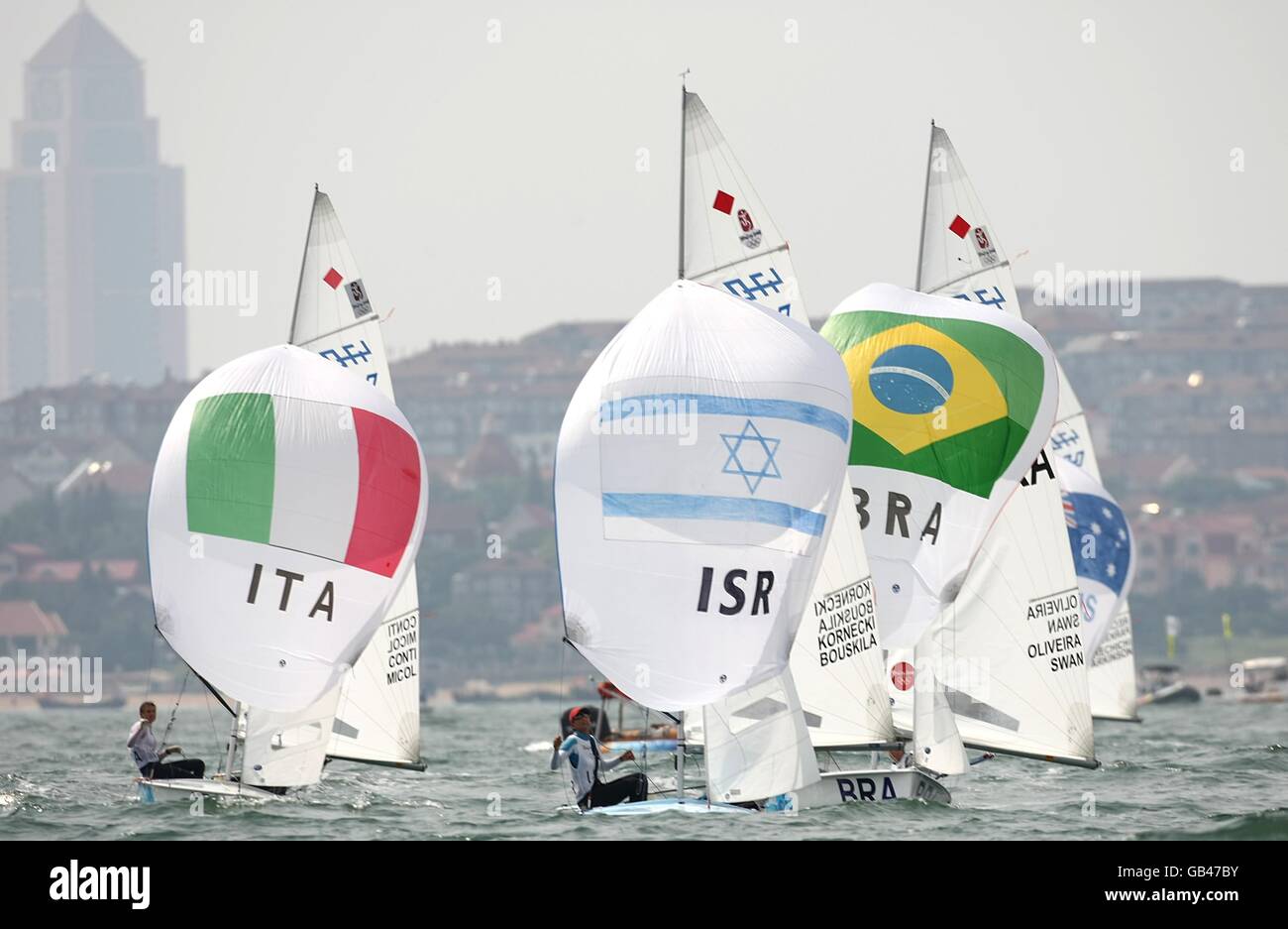 (l-r) Italy's Giulia Conti and Giovanna Micol, Israel's Nike Lornecki and Vered Bouskila and Brazil's Fernanda Oliveira and Isabel Swan compete in their final class race of the Women's 470 class during the 2008 Beijing Olympic Games' Sailing Centre in Qingdao, China. Stock Photo